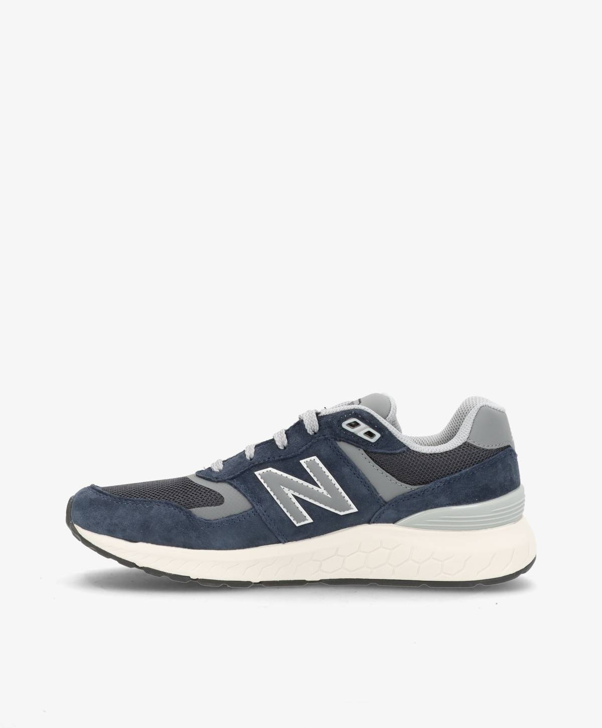 Mørkeblå og grå løbesko med hvid sål og "N" logo på siden.