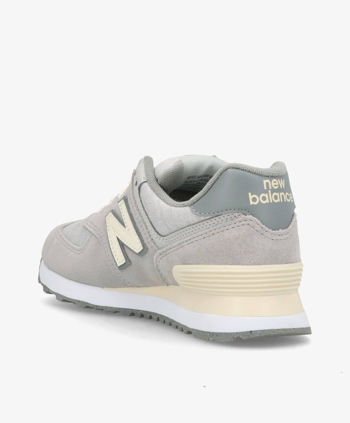 Grå New Balance sneaker set fra siden med hvid sål og beige detaljer.
