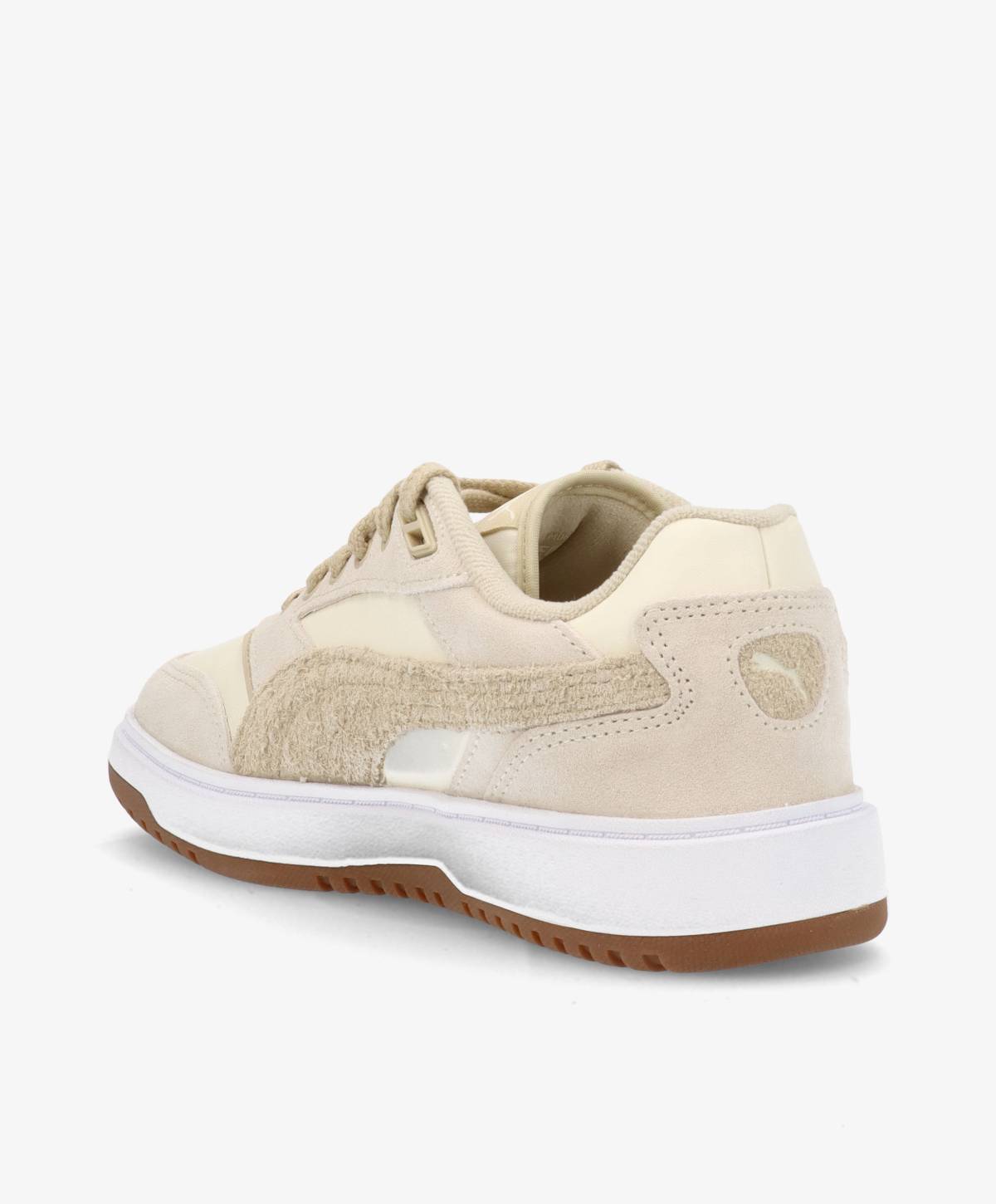 Beige sneaker med hvid sål og brun gummibund, set fra siden.