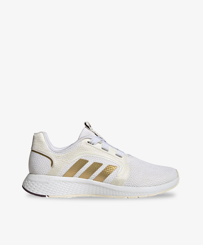 Adidas sneakers i hvid med guld striber.