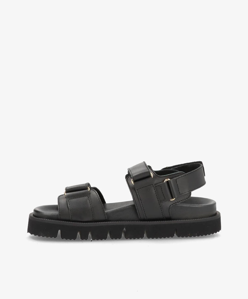 Sort damesandal med justerbare stropper og tyk sål.